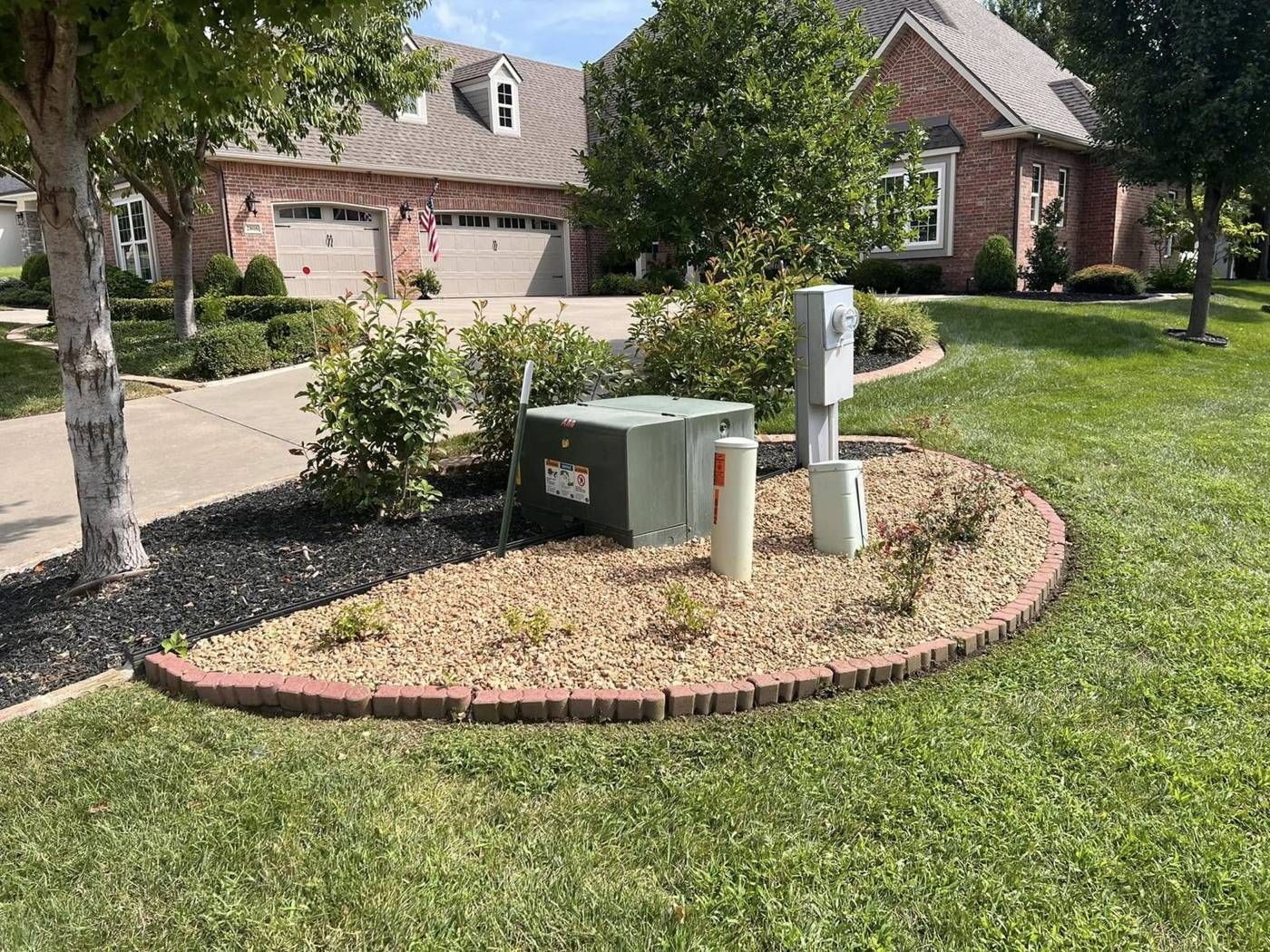 Landscaped island bed hiding utility boxes