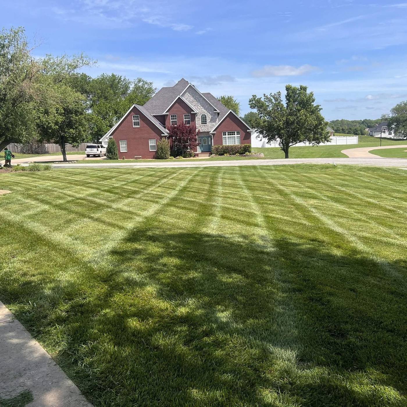 Freshly mowed lawn with crisp diagonal stripes in Carl Junction