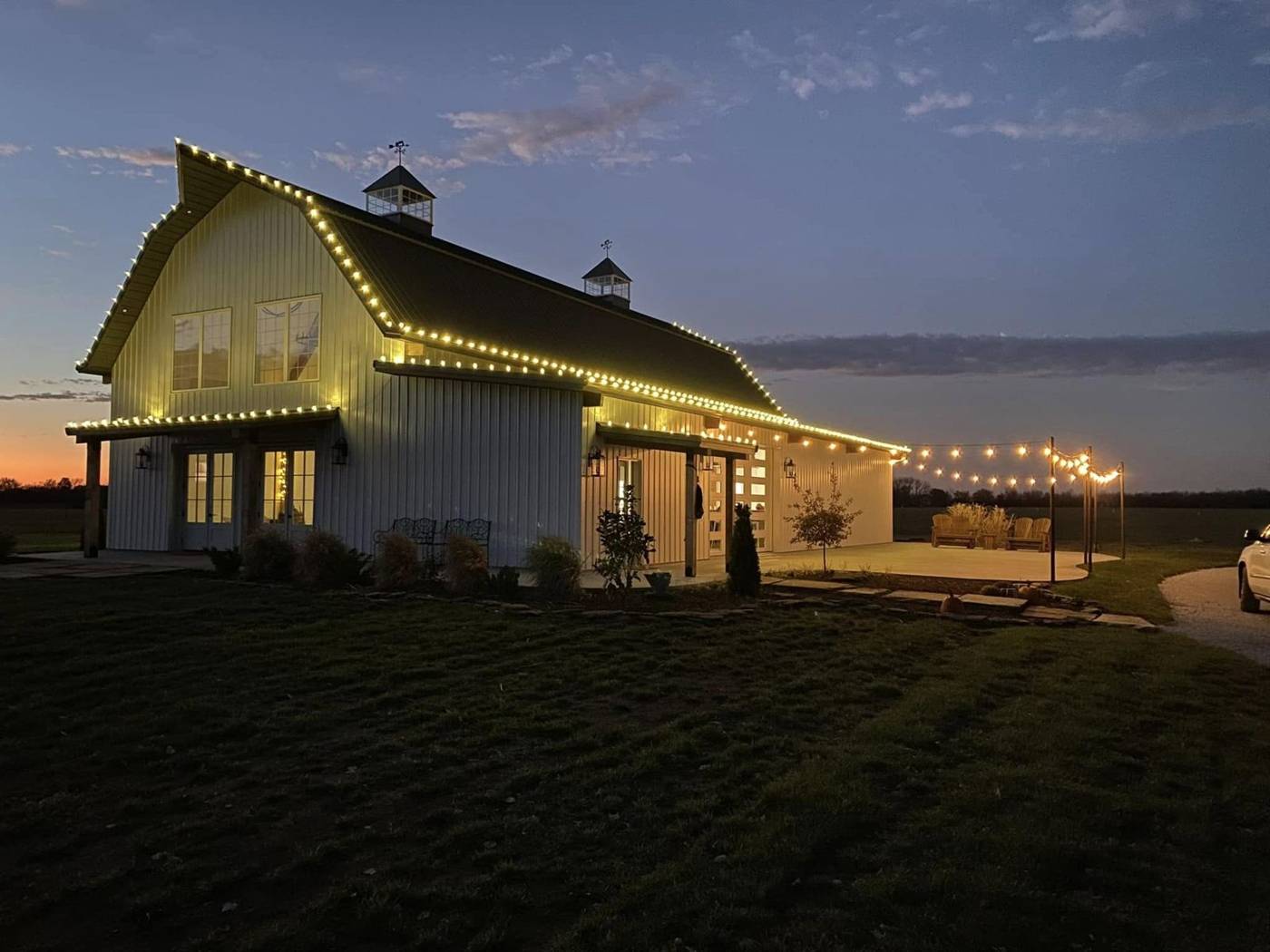 Barn venue outlined with Christmas lights installed by TC