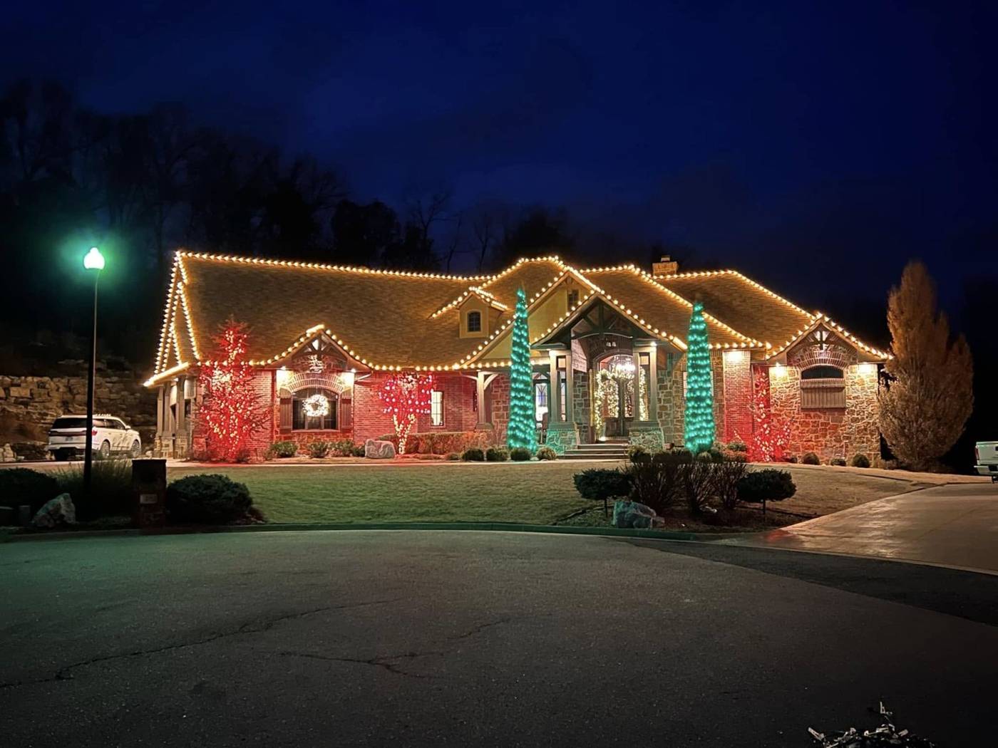 Home outlined in warm white Christmas lights