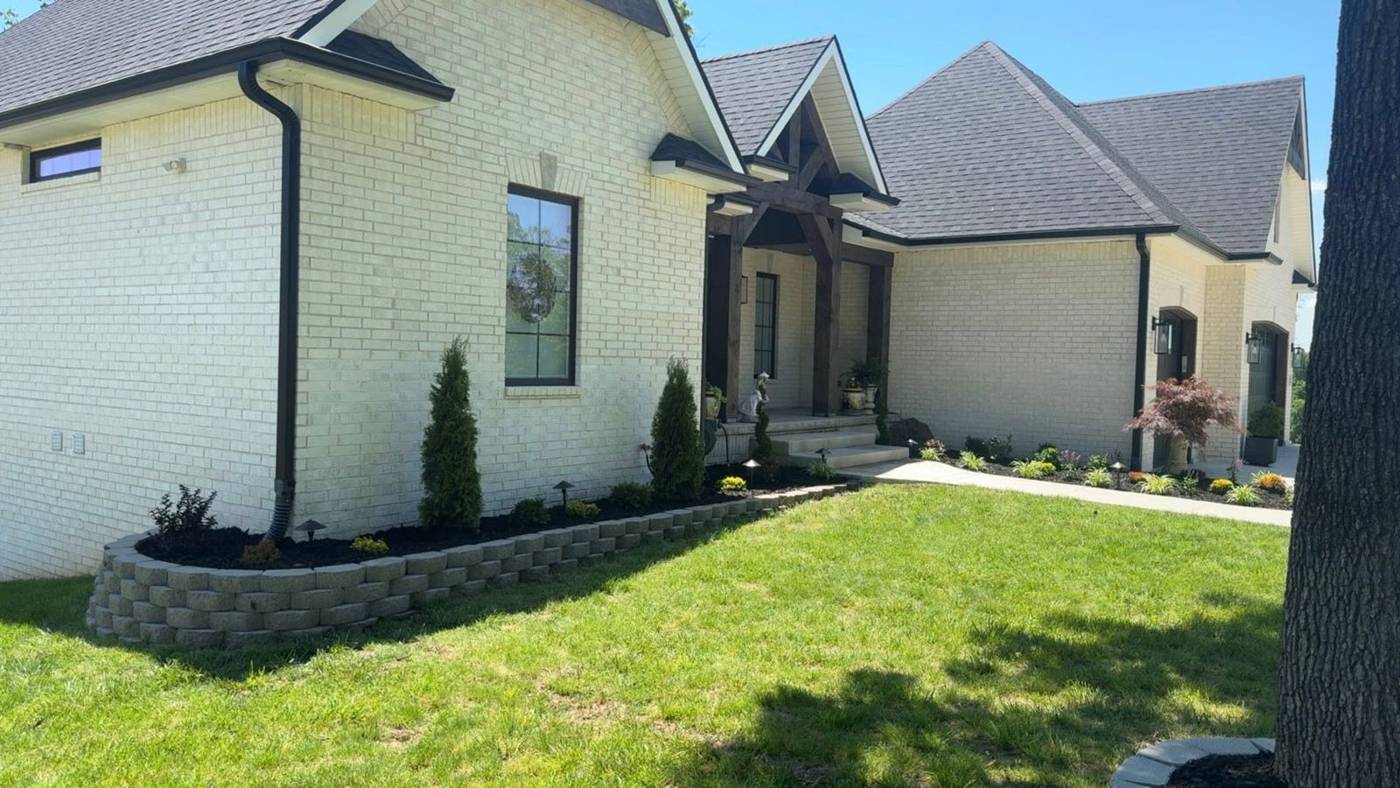 New landscape install with retaining wall and fresh plantings