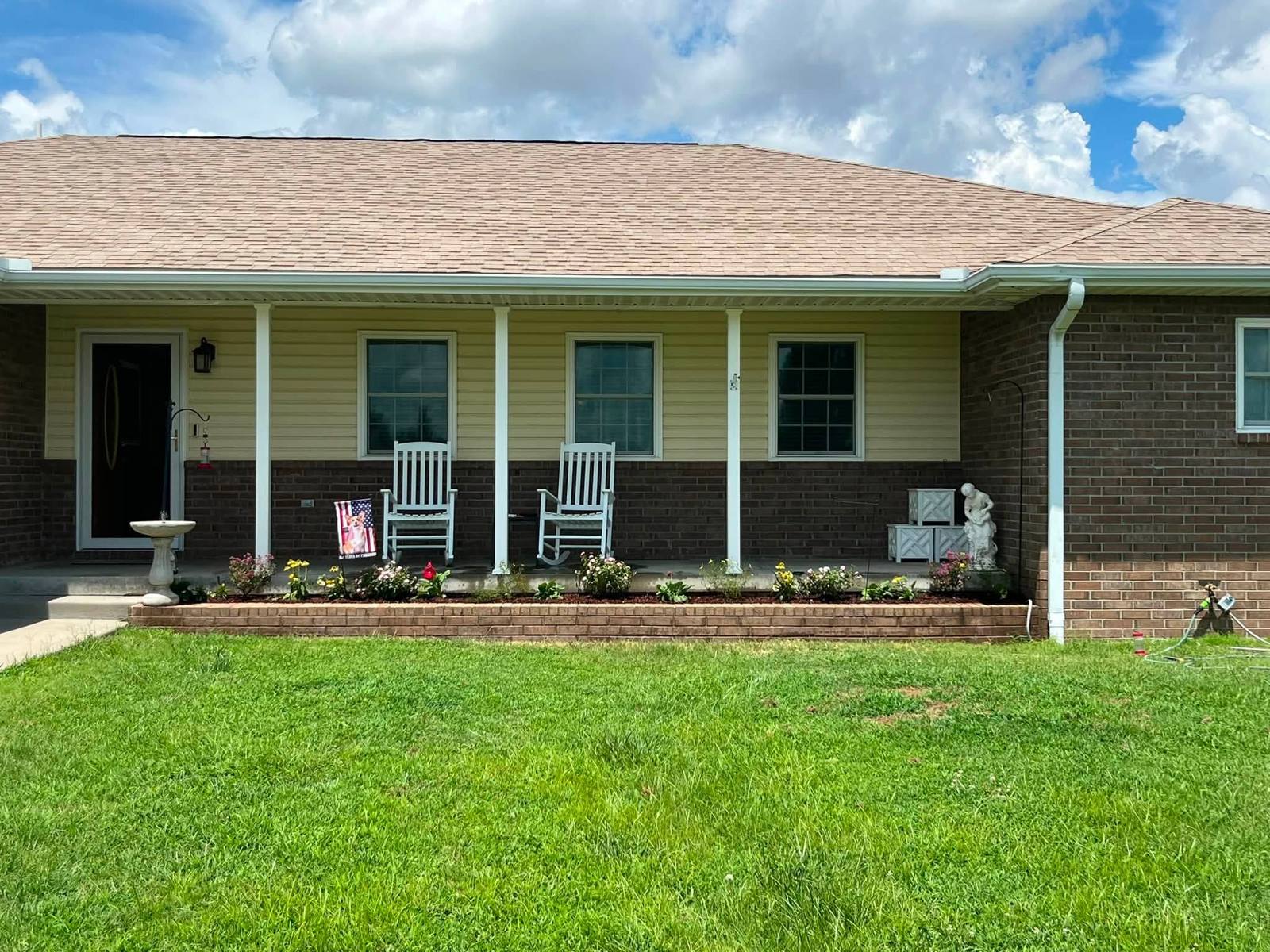 Front porch with a freshly mulched and planted flower bed