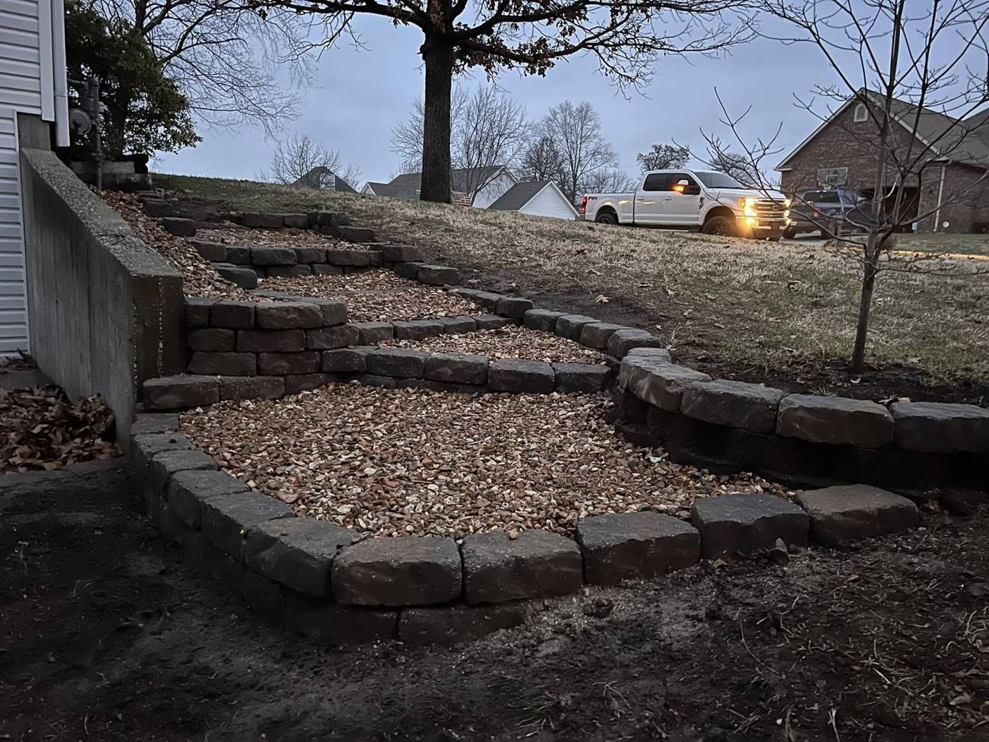 Same hillside with new stone block steps and gravel treads