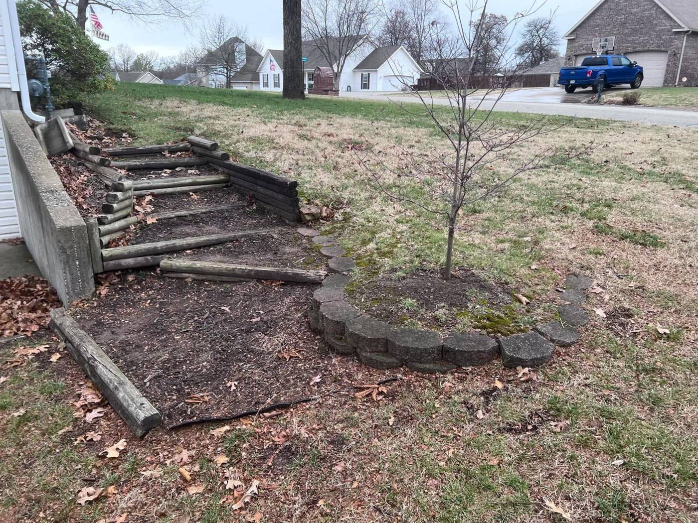 Hillside with rotting timber steps before the project